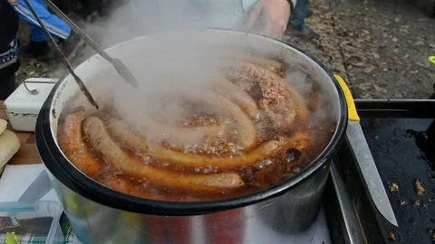 Traditionally method preparing sausages outdoors for sale to customers in Serbia Stock Footage 72604851