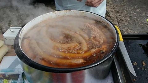 Traditionally method preparing sausages outdoors for sale to customers in Serbia Stock Footage 73498076