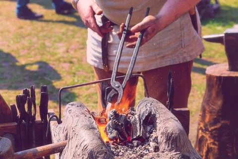 Traditions blacksmith reconstruction making weapons burning horn furnace meta Stock Photos