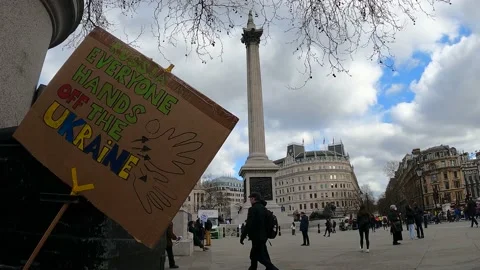 Trafalgare square column, London march support ukraine sign, russian invasion Stock Footage 171455934