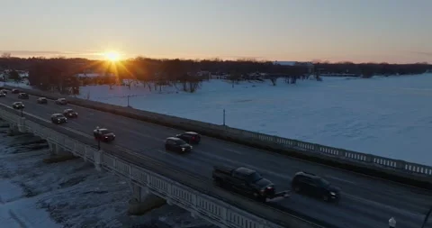 Traffic On 169 Bridge At Sunset In Winter Champlin Minnesota - Drone Pan Stock Footage 228894404