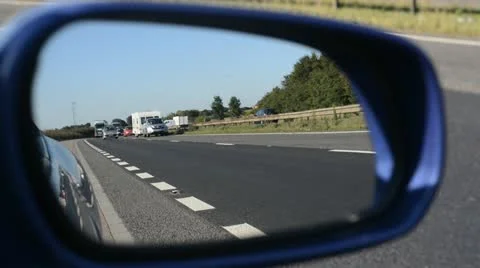 Traffic on the a1/m reflected in vehicle wing mirror Stock Footage 12387604