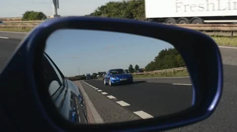 Traffic on the a1/m reflected in vehicle wing mirror Stock Footage 12603429