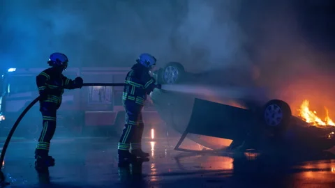 Traffic Accident with Burning Car and Firefighters Stock Footage 295791564