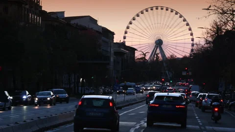 Traffic along the avenues of the center of Florence with the Ferris wheel Stock Footage 166321967