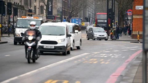 Traffic along Euston Road including a red London Double Decker Bus Stock Footage 127384513