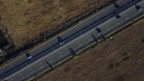 Traffic along a highway during sunset as seen from above Stock Footage 247379014