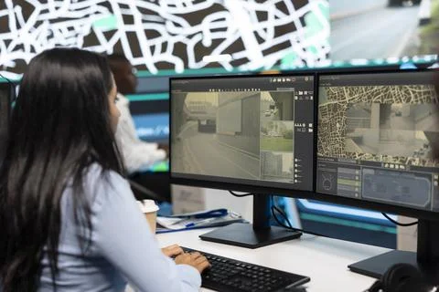 Traffic analyst uses computer to review road cameras footage Stock Photos