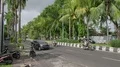 Traffic and palm tree main road scenery with vehicles and motorbikes in Bali 4k or 4k+ Resolution