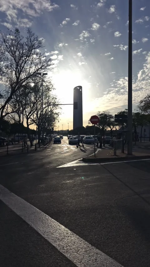 Traffic and pedestrians at a busy intersection with the Torre Sevilla skyscraper Stock-Footage 333702104