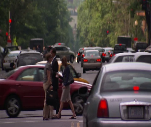 Traffic and pedestrians pass through intersection on K Street Stock Footage 86748715