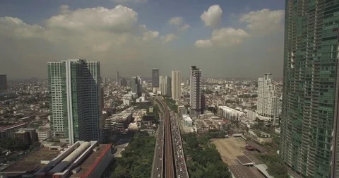 Traffic and Sky Train On Taksin Bridge, Bangkok, Ascending Aerial Shot Stock Footage 73889372