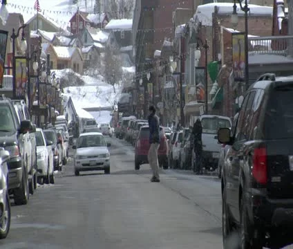 Traffic and snow falling On Main St., Park city Utah Stock Footage 21670791
