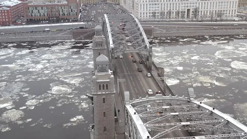 Traffic on the arch bridge. ice drift on the Neva river. Aerial view Stock Footage 125797499