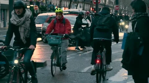 Traffic on a bicycle path in slow motion on a rainy day in Paris Stock Footage 295587193
