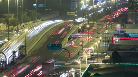 Traffic on a big road junction in Ajman aerial view from rooftop at night Vidéo 173499737