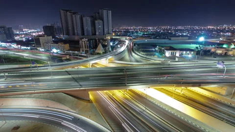 Traffic on a big road junction in Ajman aerial view from rooftop at night Vidéo 173501221