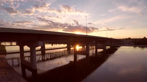 Traffic bridge at sunset across a river Stock Footage 43889632