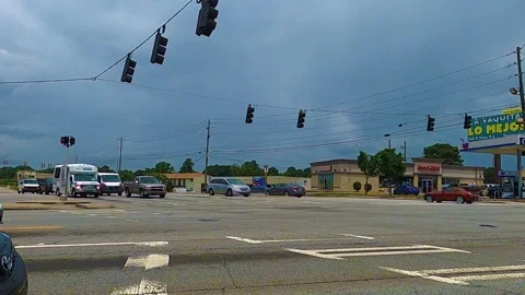 Traffic on Buford Hwy at a busy intersection on a cloudy day Stock Footage 143213985