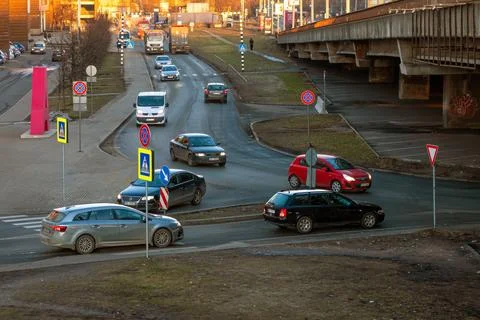 Traffic at a busy intersection during the late afternoon in an urban area Stock Photos