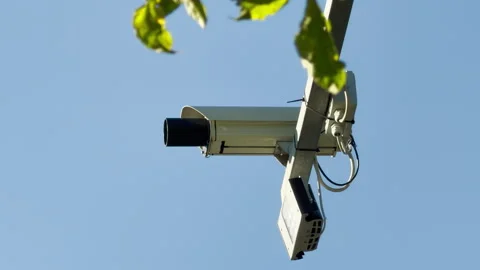 Traffic Camera Monitors Busy Road Under Clear Blue Sky Stock Footage 336877504