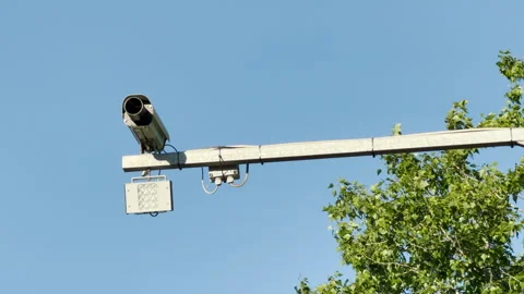 Traffic Camera Monitors The Road Under A Clear Blue Sky Stock Footage 336877480