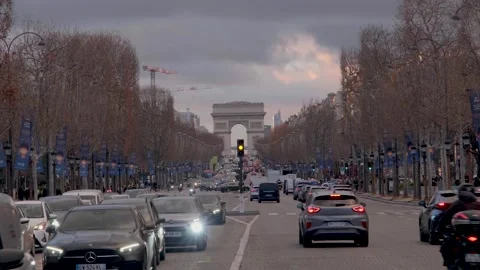 Traffic on the Champs Élysées in Paris, with l'Arc de Triomphe in the background Stock Footage 305611316