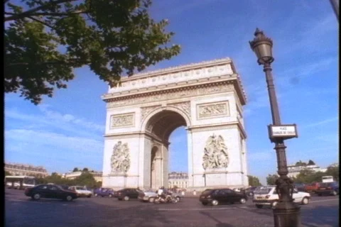 Traffic circles the Arc de Triomphe in Paris. Stock Footage