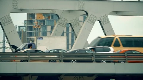 Traffic on a city car bridge. Telephoto lens pan shot Stock Footage