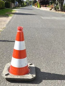 A traffic cone on an empty road 스톡 사진