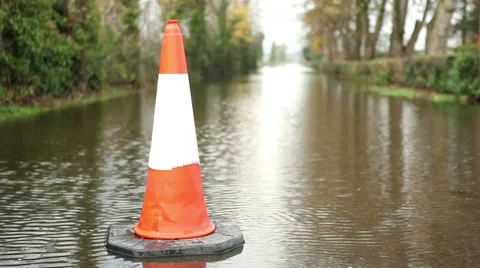 Traffic cone at flooded road, warning sign for inundated street Stock Footage 44644070
