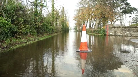 Traffic cone at flooded road, warning sign for inundated street Video stock 45159591