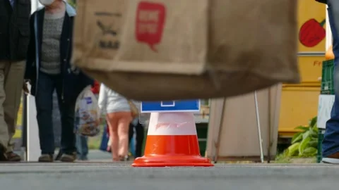 Traffic cone with sign Use face mask on a weekly market, mask requirement, Ge Stock Footage 139128079
