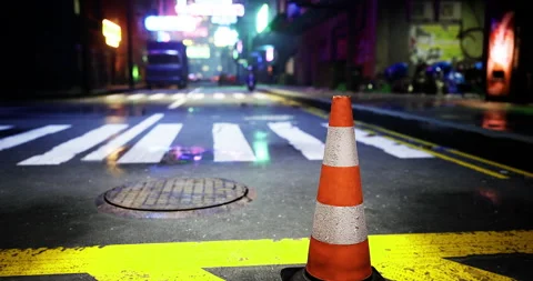 Traffic cone stands on an empty neon lit street at night 스톡 동영상 308808052
