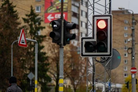 Traffic control lights and triangular warning sign at street crossing Stock Photos