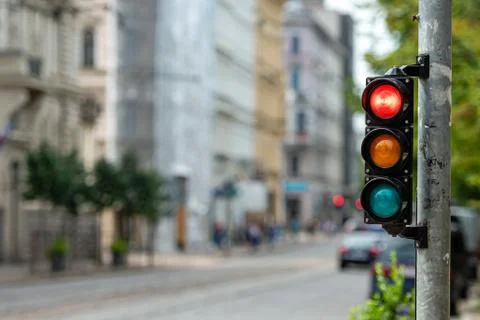 Traffic control semaphore with red light on a defocused city background Stock Photos
