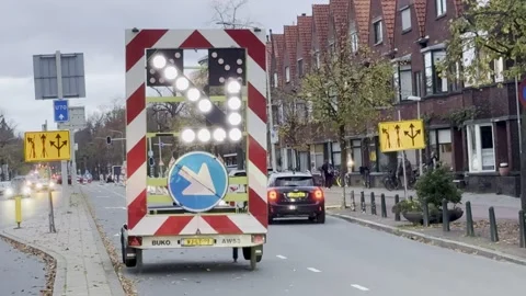 Traffic control sign directing vehicles on a city street Stock Footage 305152547