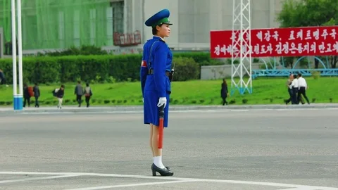 The traffic controller on the busy street of Pyongyang Video stock 84117509