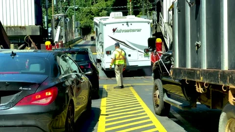 Traffic Controller Controls the Traffic Discharged from the Ferry. Slow Motion. Stock Footage 157747695