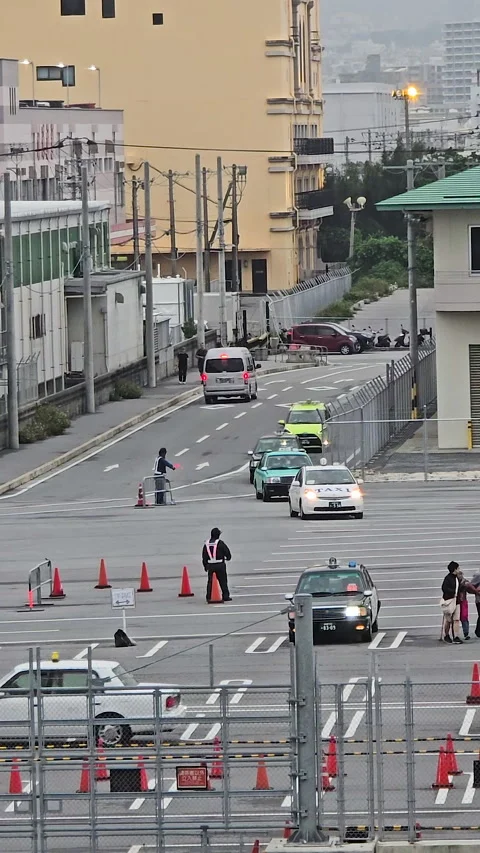 Traffic controller in uniform directing multiple taxis and other vehicles at Stock Footage 325958722