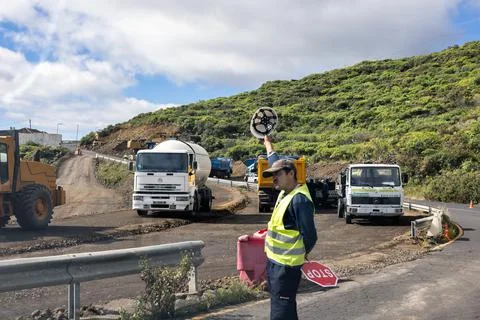 Traffic controller at work near road construction activities, La Palma Stock Photos