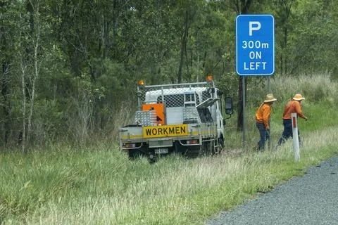 Traffic Controllers Setting Up Equipment On Work Site Stock Photos