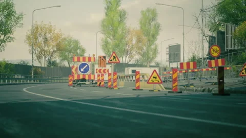 Traffic controls set up for road construction in an urban area during daylight Vídeos de archivo 304504341