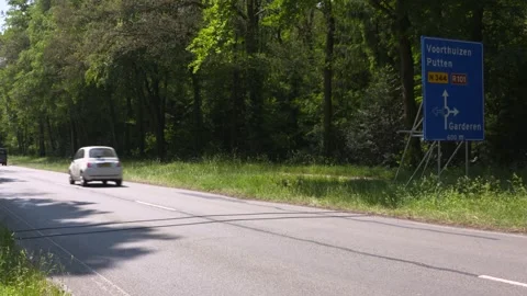 Traffic count system, road tubes cables lay across the road, vehicles passing by Stock Footage 243068865