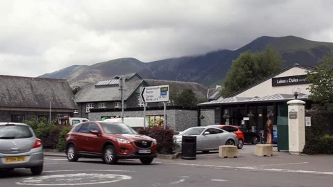 Traffic crosses a mini-roundabout, Main Street, Keswick, Cumbria, Lake District. Stock Footage 96251199