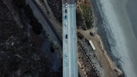 Traffic crossing a Bridge as drone camera faces down Stock Footage 84758280