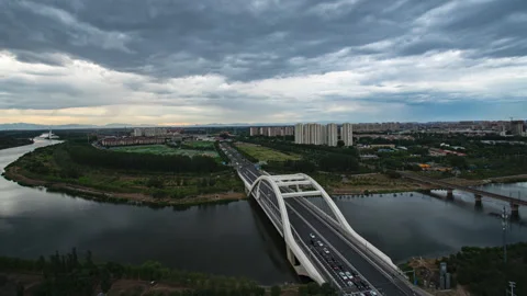 Traffic Crossing River Bridge Under Overcast Skies Timelapse Stock Footage 320699126