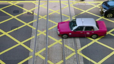 Traffic Crossing At A Road Intersection With Yellow Markings In Hong Kong Stock Footage 334761406