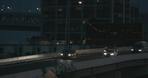 Traffic on the Delaware Expressway, with red neon reeflected in building Stock-Footage 160917443