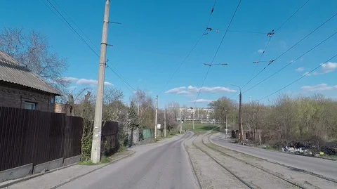 Traffic down the old street with bad road tram tracks, debris on the side of the Stock Footage 127684936